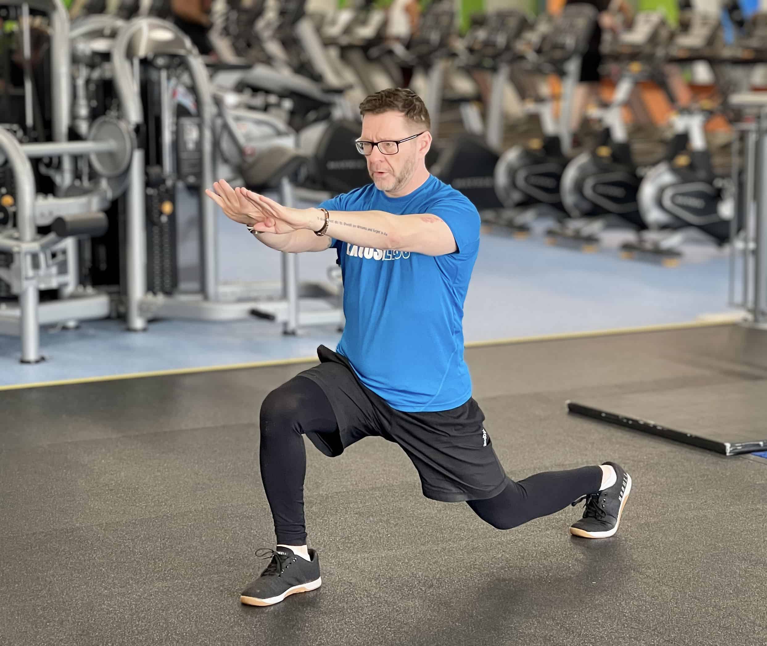 Personal Trainer Basingstoke helping client with lunge exercise - The Fit Coach